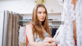 woman-doing-shopping-and-choosing-clothes-in-PDEP6XU